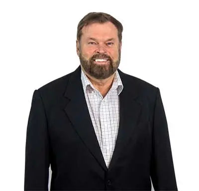 Bob Greska smiling wearing black blazer and plaid button down shirt   - Greskas c60 carbon 60 supplement