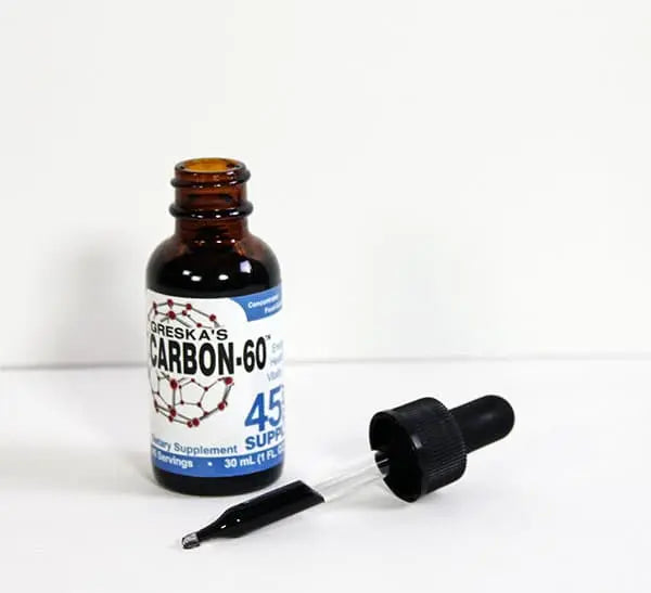 Open bottle with pure black carbon 60 in the dropper  - Greskas c60 carbon 60 supplement